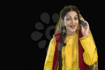 Woman in traditional Punjabi dress using a mobile phone