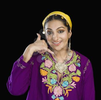 Woman in Kashmiri dress showing call me gesture