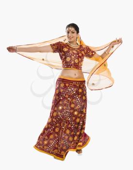Woman dancing in bright red lehenga choli