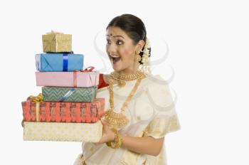 Woman holding gifts and smiling