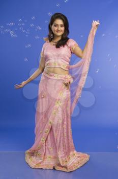 Portrait of a beautiful woman posing in traditional pink dress