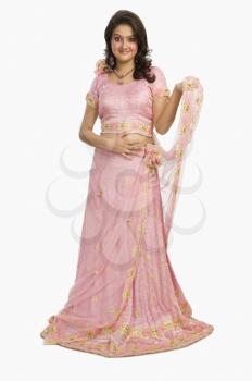 Portrait of a beautiful woman posing in traditional pink dress