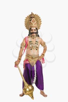 Portrait of a man dressed-up as Ravana the Hindu mythological character and holding a mace