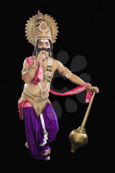 Stage artist dressed-up as Ravana and thinking