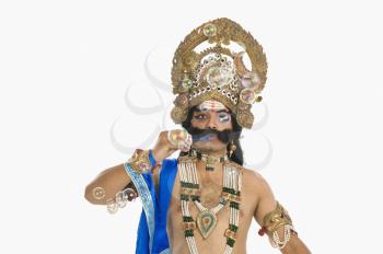 Man dressed-up as Ravana and blowing bubbles
