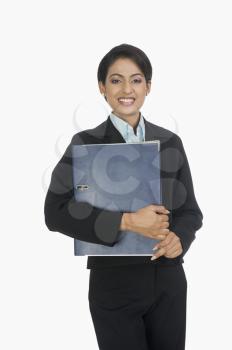 Portrait of a businesswoman smiling with a file