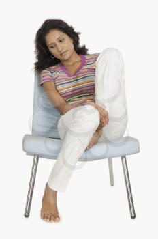 Woman sitting on a chair and looking serious
