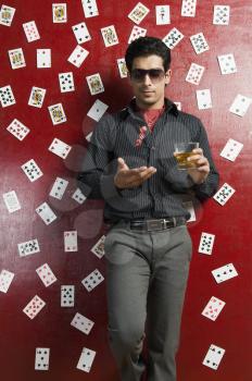 Man drinking whiskey and tossing dices