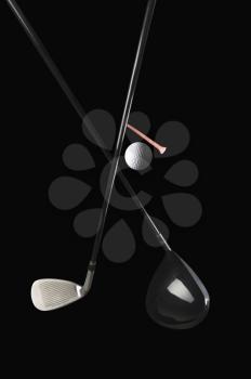 Close-up of golf clubs with a golf ball