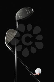 Close-up of golf clubs with a golf ball