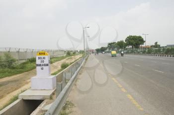 Milestone at the roadside, National Highway 8, New Delhi, India