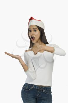 Woman wearing a Santa hat and gesturing