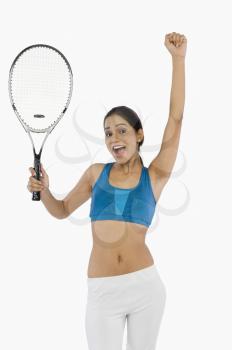 Woman holding a tennis racket and celebrating success