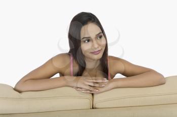Close-up of a woman leaning on a couch