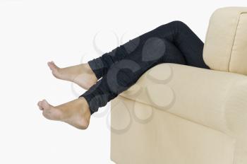 Low section view of a woman lying on a couch