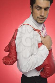 Businessman holding boxing gloves