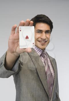 Businessman showing ace of hearts card