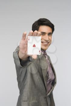 Businessman showing ace of hearts card