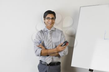Portrait of a teacher smiling in front of a whiteboard