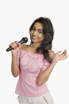 Portrait of a woman singing into a microphone