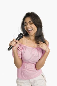 Woman singing into a microphone