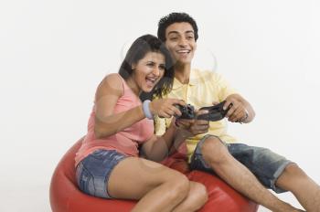 Couple playing a video game on a bean bag