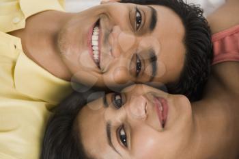 Close-up of a couple lying on the bed and smiling