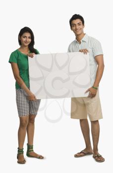 Couple holding a blank placard