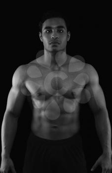Portrait of a muscular man showing his abs
