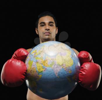 Portrait of a male boxer holding a globe