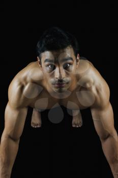 Portrait of a muscular man doing push-ups