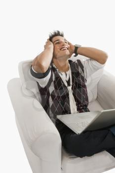 Close-up of a man looking excited while using a laptop