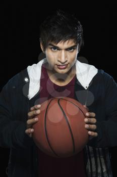 Portrait of a man holding a basketball