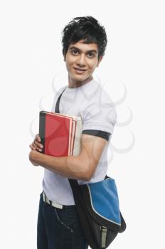 Portrait of a college student holding notebooks
