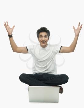 Portrait of a man raising his hands in excitement