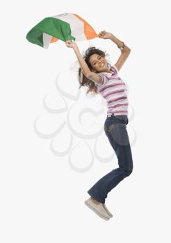 Portrait of a woman jumping with an Indian flag