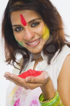 Portrait of a woman holding Holi colors