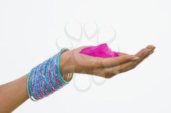 Close-up of a woman's hand holding Holi colors