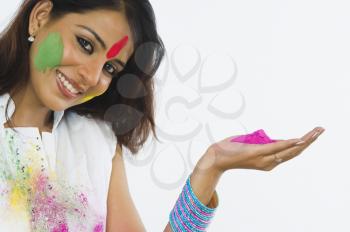 Portrait of a woman holding Holi colors