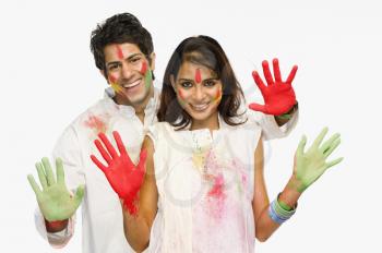 Couple showing their colored hands on Holi