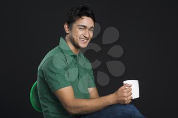 Portrait of a man holding a cup of coffee