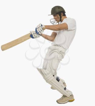 Cricket batsman playing a square cut shot