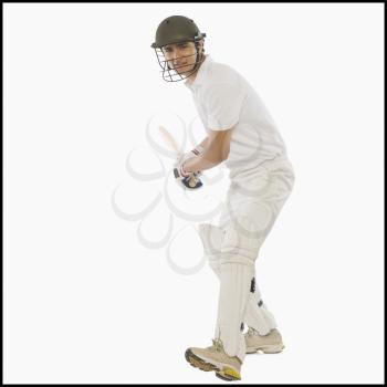 Cricket batsman with a high back lift