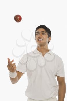 Bowler tossing a cricket ball