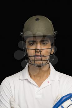 Portrait of a cricket batsman wearing a cricket helmet