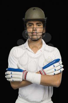 Portrait of a cricket batsman with arms crossed