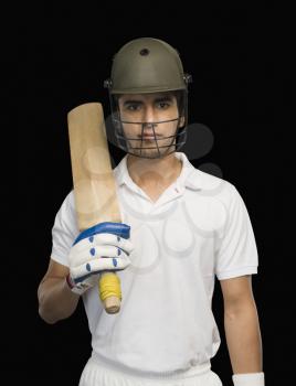 Portrait of a cricket batsman holding a cricket bat
