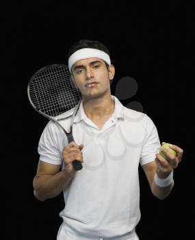 Tennis player with a tennis racket and a ball