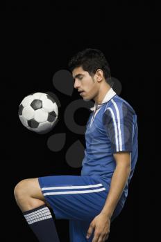 Soccer player practicing with a soccer ball
