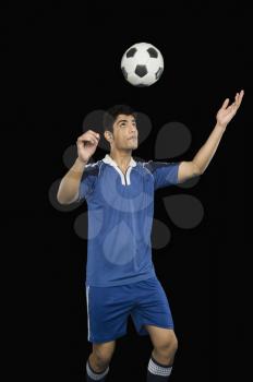 Soccer player practicing heading the ball